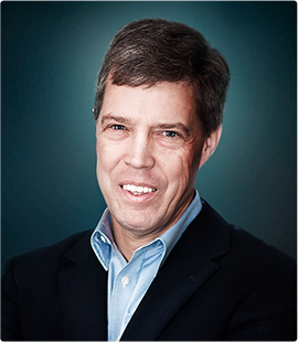 Headshot of a man in a dark suit