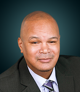Headshot of a man in a dark suit